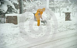 A man shoveling snow in a blizzard