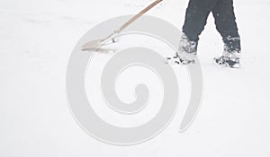 Man shoveling snow at a footpath
