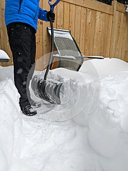 Man shoveling snow by the residential house