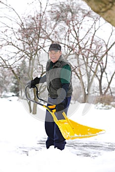 Man shoveling snow smiling