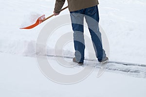 Man shoveling snow at wintertime