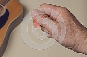 Man show how to correctly hold a guitar pick photo