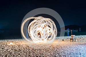 Man show spin fire on beach