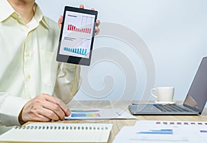 man show various business graph on tablet with copy space