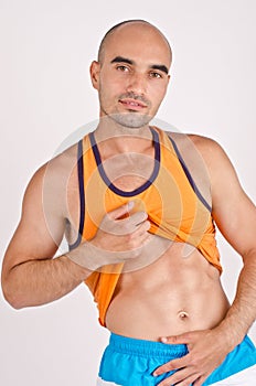 Man showing abs. Man lifting his shirt showing six pack abdominal.