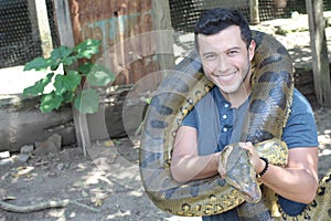 Man showing affection for a gigantic snake