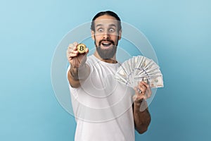 Man showing bitcoin and big fan of dollars banknotes, e-commerce, crypto currency.