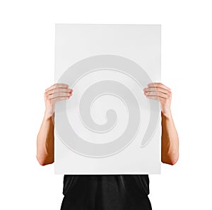 Man showing blank white big A2 paper, covers the face. Leaflet presentation