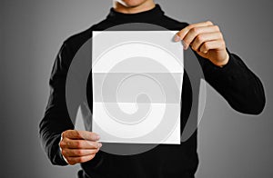 Man showing blank white flyer brochure booklet. Leaflet presenta