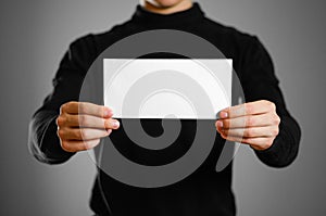 Man showing blank white flyer brochure booklet. Leaflet presenta