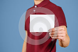 Man showing blank white flyer brochure booklet. Leaflet presentation