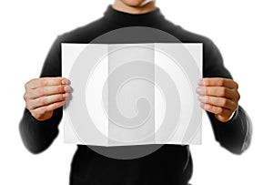 Man showing blank white flyer brochure booklet. Leaflet presentation. Pamphlet hold hands. Man show clear offset paper