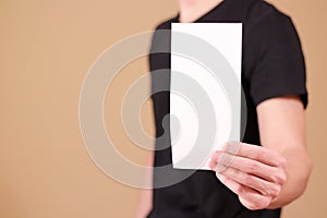 Man showing blank white flyer brochure booklet. Leaflet presentation. Pamphlet hold hands. Man show clear offset paper. Sheet