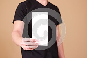 Man showing blank white flyer brochure booklet. Leaflet presentation. Pamphlet hold hands. Man show clear offset paper. Sheet