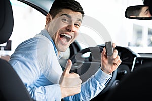 Man Showing Car Key And Thumb Up