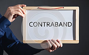 Man showing Contraband word on whiteboard