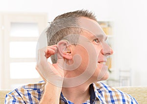 Man showing deaf aids