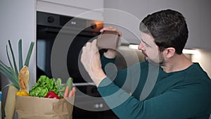 Man showing empty wallet after doing grocery shopping