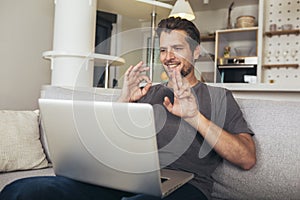 Man showing gesture in sign language using laptop, make video call