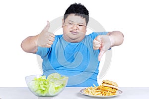 Man showing healthy and unhealthy food