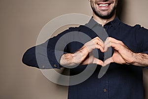 Man showing HEART gesture in sign language