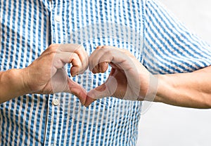 Man showing heart shape made with hands