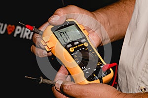 Man showing a multimeter.