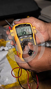 Man showing a multimeter.
