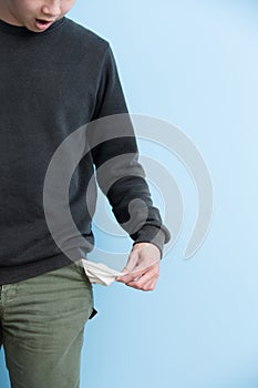 Man showing his empty pockets