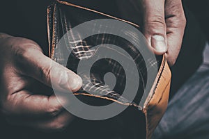 Man Showing His Empty Wallet - No Money Left Concept photo