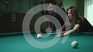 Man Showing His Girl Where To Hit The Ball - Young Woman Receiving Advice On Shooting Pool Ball While Playing Billiards