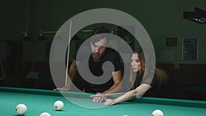 Man Showing His Girlfriend Where To Hit The Ball - Young Woman Receiving Advice On Shooting Pool Ball While Playing