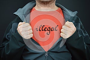 A man showing his t-shirt with the word illegal on it