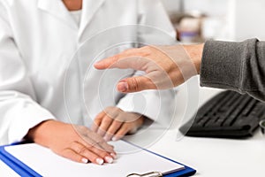 Man showing his tremulous hand on the clinic, concept tremor, parkinson and stress