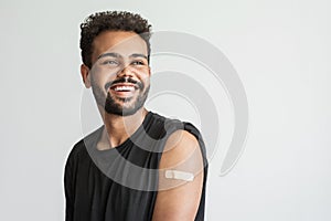 Man showing his vaccinated arm with plaster, got COVID-19 vaccine