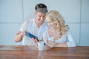 Man showing his wife something on a tablet