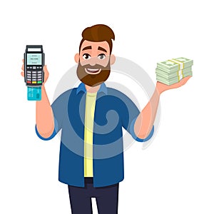 Man is showing or holding a POS terminal or credit, debit card swiping payment machine and bunch or cash, money, currency, bank. photo