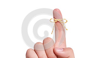 Man showing index finger with tied striped bow as reminder on white background, closeup