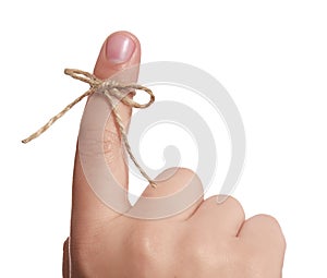Man showing index finger with tied striped bow as reminder on white background, closeup