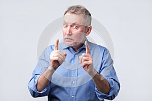 Man showing index fingers up, giving advice