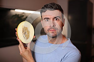 Man showing the interior of a fruit