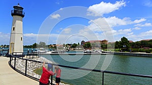 Man showing the lighthouse to his kid on a sunny day in Rockwall Lake