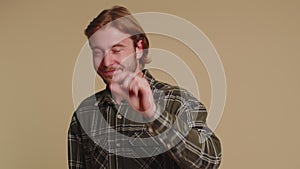 Man showing a little bit gesture with sceptic smile, showing minimum sign, measuring small size