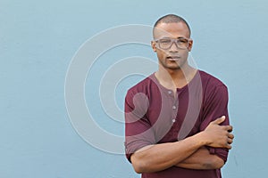 Man showing neutral expression closeup with arms crossed