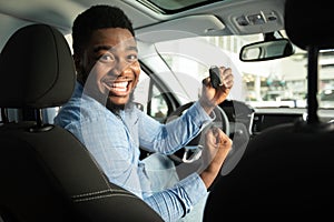 Man Showing New Car Key Gesturing Yes Sitting In Auto