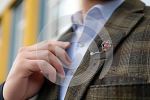 man showing off a bohostyle lapel pin on a blazer