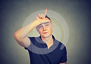 Man showing offensive loser sign