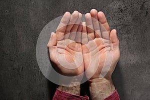 Man showing palms at table, top view.