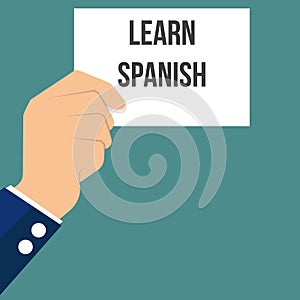 Man showing paper LEARN SPANISH text