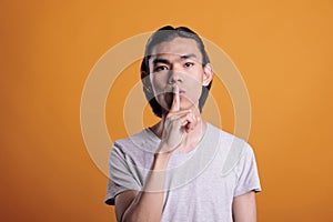 Man showing quiet gesture, silence concept